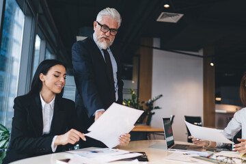 Businesspeople reading documents in workshop