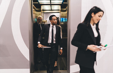 Multiethnic colleagues at work leaving elevator © BullRun