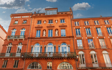 Fototapeta na wymiar Facades of buildings in trinity square in Toulouse, Occitanie, France