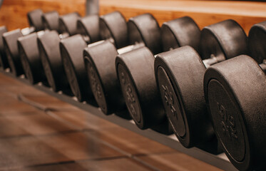 Naklejka na ściany i meble Dumbbells of different weight in the gym