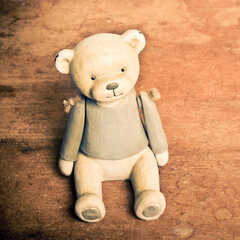 vintage teddy bear on wood