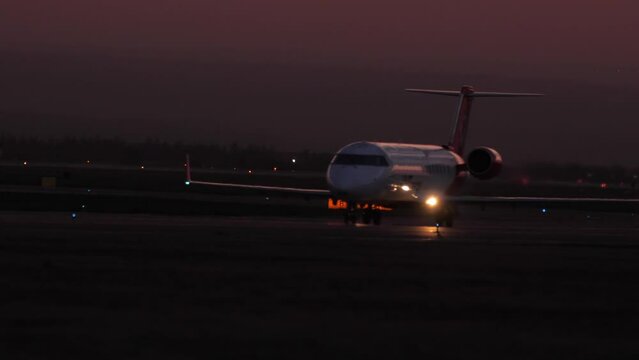 Footage of aircraft at sunset. Night flight, jet plane on the runway acceleration to take off, side view. Tourism and travel concept