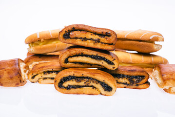 Delicious sweet buns with jam and poppy seeds. And cream pies. On a white isolated background.