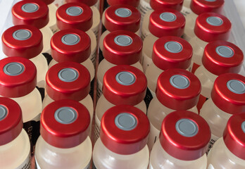 vaccination and drug vials in box on pharmacy or hospital shelf