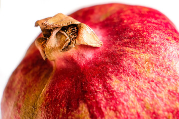 Closeup of pomegranate isolated on white background