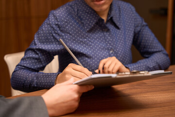 African American female signs the document to start treatment