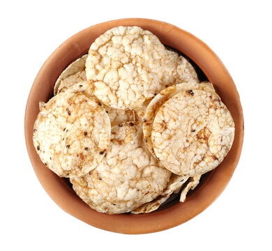 Brown Rice Crisps, Chips Pile With Chia Seeds And Quinoa In Clay Pot Isolated On White, Top View 