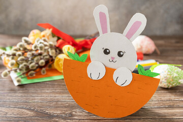 Easter card gift Easter bunny on a wooden table. Handmade. Project of children's creativity, handicrafts, crafts for kids.