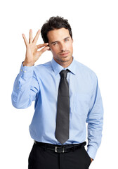 Portrait, gesture and small with a business man in studio isolated on a white background to sign a tiny symbol. Social media, review and feedback with a male employee posing on blank marketing space