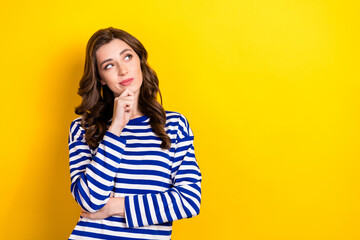 Photo portrait of pretty young girl look skeptical empty space consider dressed stylish striped...