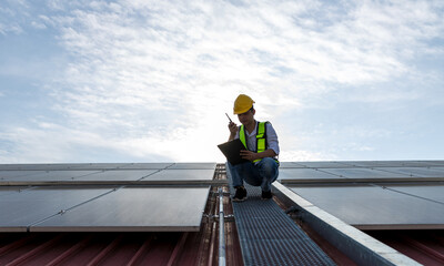 Engineer working setup Solar panel at the roof top. Engineer or worker work on solar panels or solar cells on the roof of business building