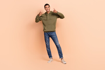 Full length photo of cheerful man wear stylish clothes thumbs up quality clothes sale nice offer deal isolated on beige color background