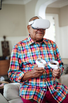 Senior man enjoying a virtual reality game