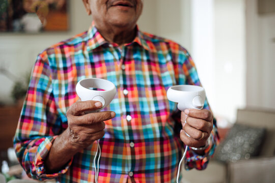 Senior man enjoying a virtual reality game