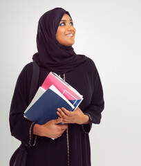 Muslim, student and thinking with an islamic girl holding books in studio on a gray background for education. Idea, learning and islam with a female pupil on a scholarship to study at university