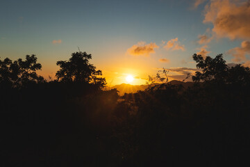 Golden sunset wide angle landscape between trees and mountains from puerto rico 