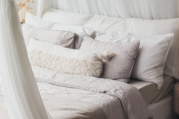 Bright Scandi-style interior in the bedroom. A linen bed or bedding. Close up interior details photo