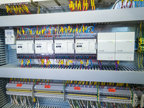 Mitsubishi PLC modules in a row in electrical cabinet of automation control system on industrial plant.