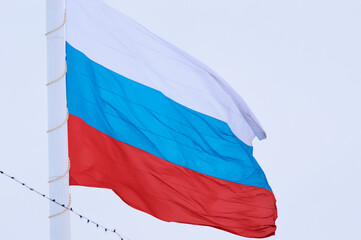 Russian flag and barbed wire close-up. Border demarcation concept. State symbol of the Russian...