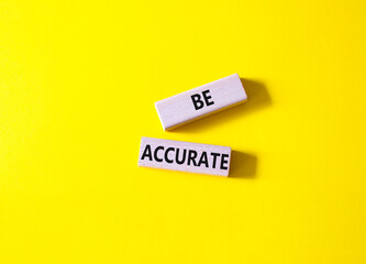 Be accurate symbol. Wooden blocks with words Be accurate. Businessman hand. Beautiful yellow background. Business and Be accurate concept. Copy space.