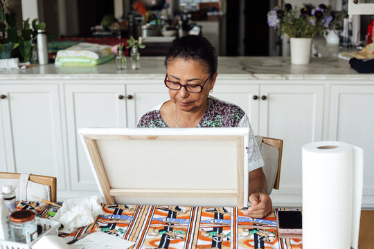 senior woman painting at home 