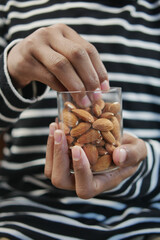 close up of almond nuts on man's hand 