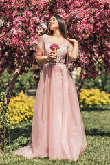 Fototapeta premium Pink flowers garden girl trees mood happiness, tourism in Asia, blooming traditional seasonal background April.waffle cone with flowers