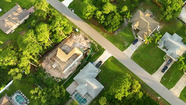 Aerial view of residential private home with wooden roofing structure under construction in Florida quiet rural area. Real estate development concept