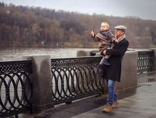 dad and son walking along the promenade