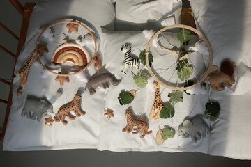 children's mobile for a bed in the style of animals lion, giraffe, zebra. decor for a children's bed