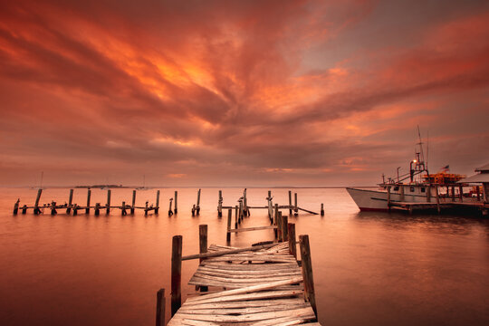 Shrimp boat at the dock in the intercostal waterway in Florida at sunset - Powered by Adobe