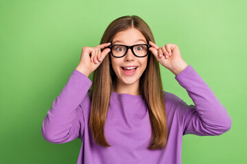 Photo of surprised clever lady wear trendy spring clothes wear spectacles rejoice nice quality isolated on green color background