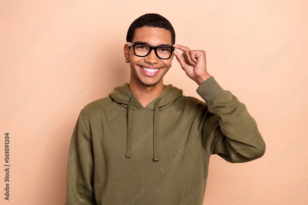 Sticker Photo of young satisfied smart college student guy wear spectacles glasses toothy beaming smile wear hoodie isolated on beige color background