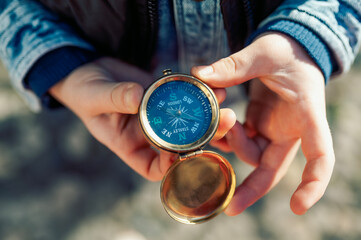 hand holding a compass