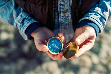 hand holding a compass