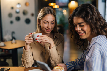 Two friends enjoy coffee together in a cafe