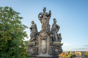 Fototapeta na wymiar Statues of Saints Barbara, Margaret and Elizabeth at Charles Bridge - Prague, Czech Republic