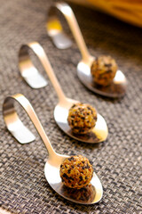 Small cream cheese balls on a little plate. Roasted sesame seeds served. Easy cheese snack food. Snacks. Closeup. Copy space. Finger food.