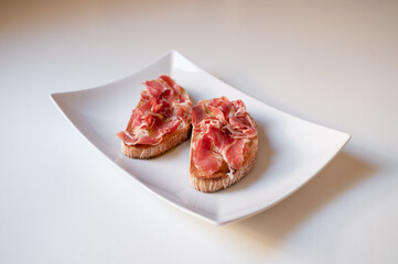 Toast with ham and oil. Traditional breakfast from Spain
