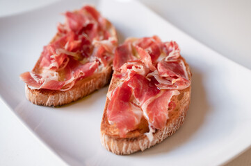 Toast with ham and oil. Traditional breakfast from Spain