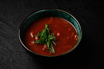 Korean Kimchi soup in black bowl on black background
