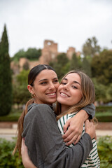 Fototapeta premium Two young women hugging in the street