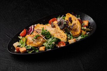 Caesar salad  on a black  background