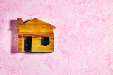 mini wooden house model on grunge background. Planning to buy property. Choose what's the best concept