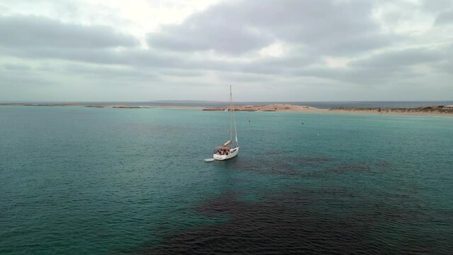 cloudy sky over Sailing yacht with dinghy. Fantastic aerial view flight drone
