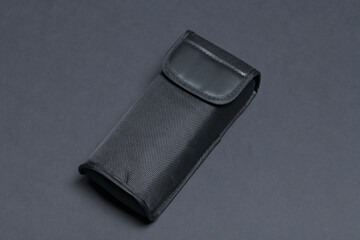 Black pouch isolated on black background