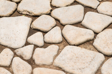 A close-up of the stone sidewalk. Pavement background texture. Stone background