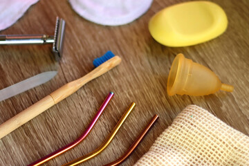 Various zero waste beauty products and kitchen utensils on wooden background. Selective focus.