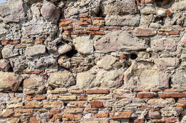 Texture of an old brick wall. Destroyed brick wall or fence.