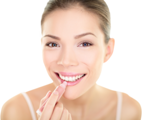 Lipstick makeup woman putting lip balm care. Beauty Asian girl applying color moisturizer on lips getting ready and looking at herself in the mirror smiling happy. Multi-ethnic Asian Caucasian model.